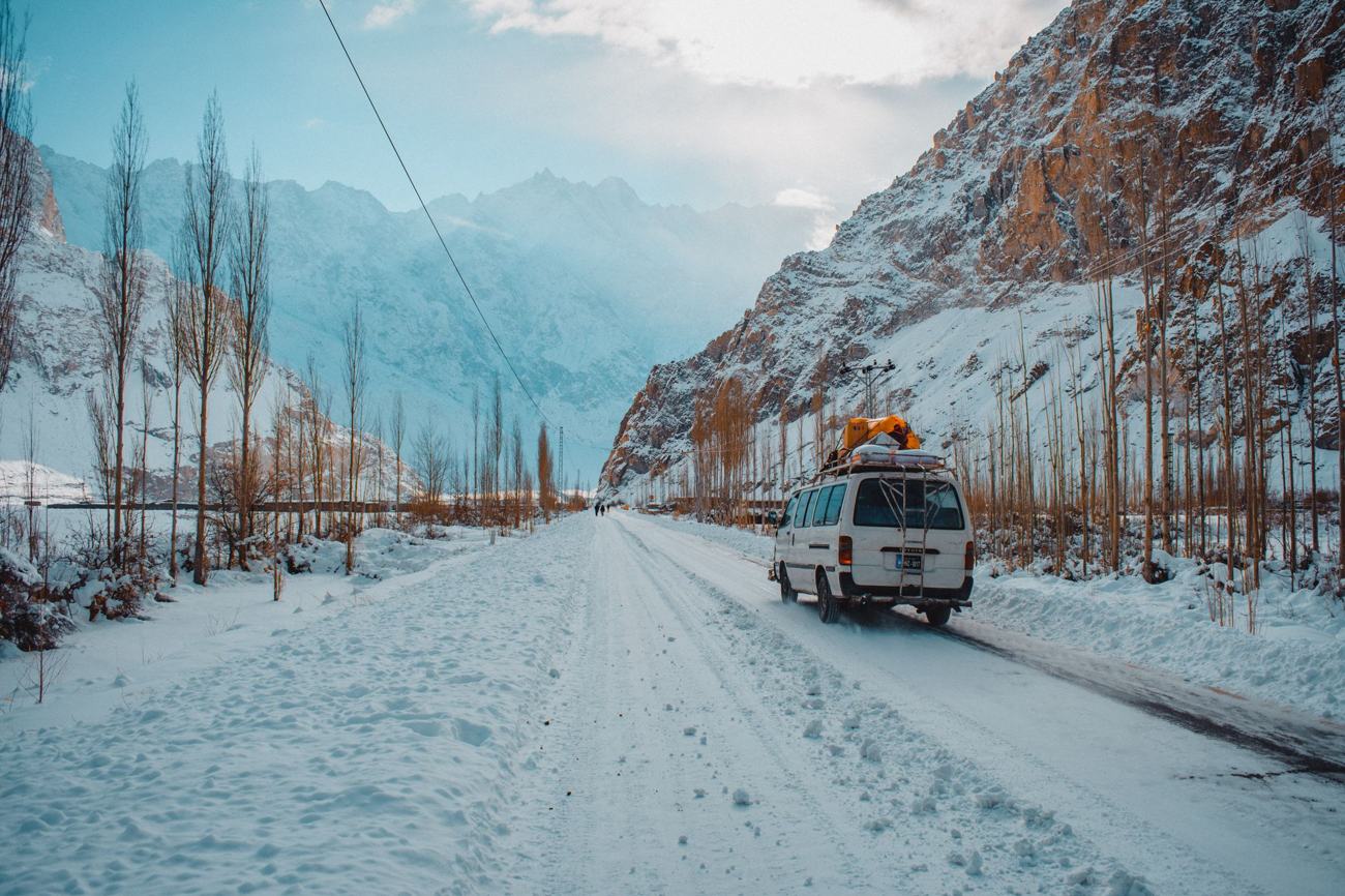 Explore the winter beauty of Hunza Nagar's snow-covered roads and majestic mountains.