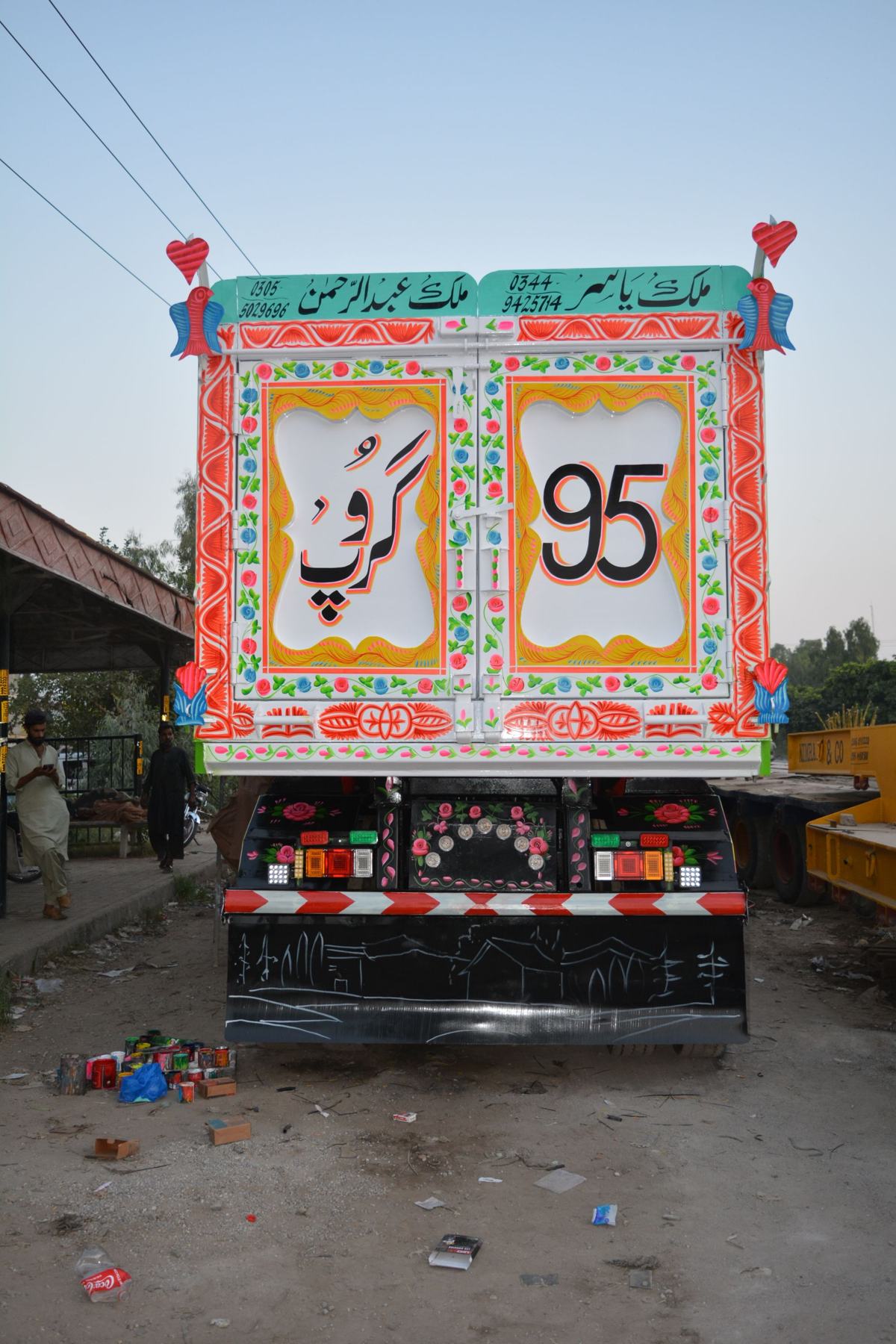 Decorative painted truck showcasing vibrant traditional motifs and colors.